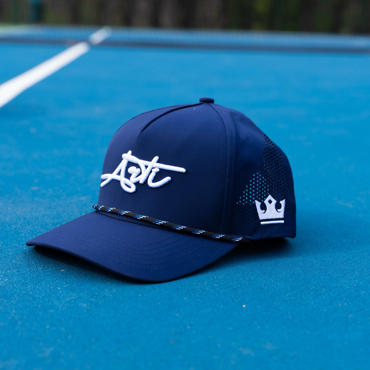 ARTI Navy Performance mesh rope hat on a pickleball court